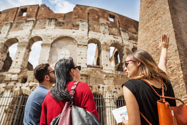 A couple with a tour guide at the Colosseum in Rome