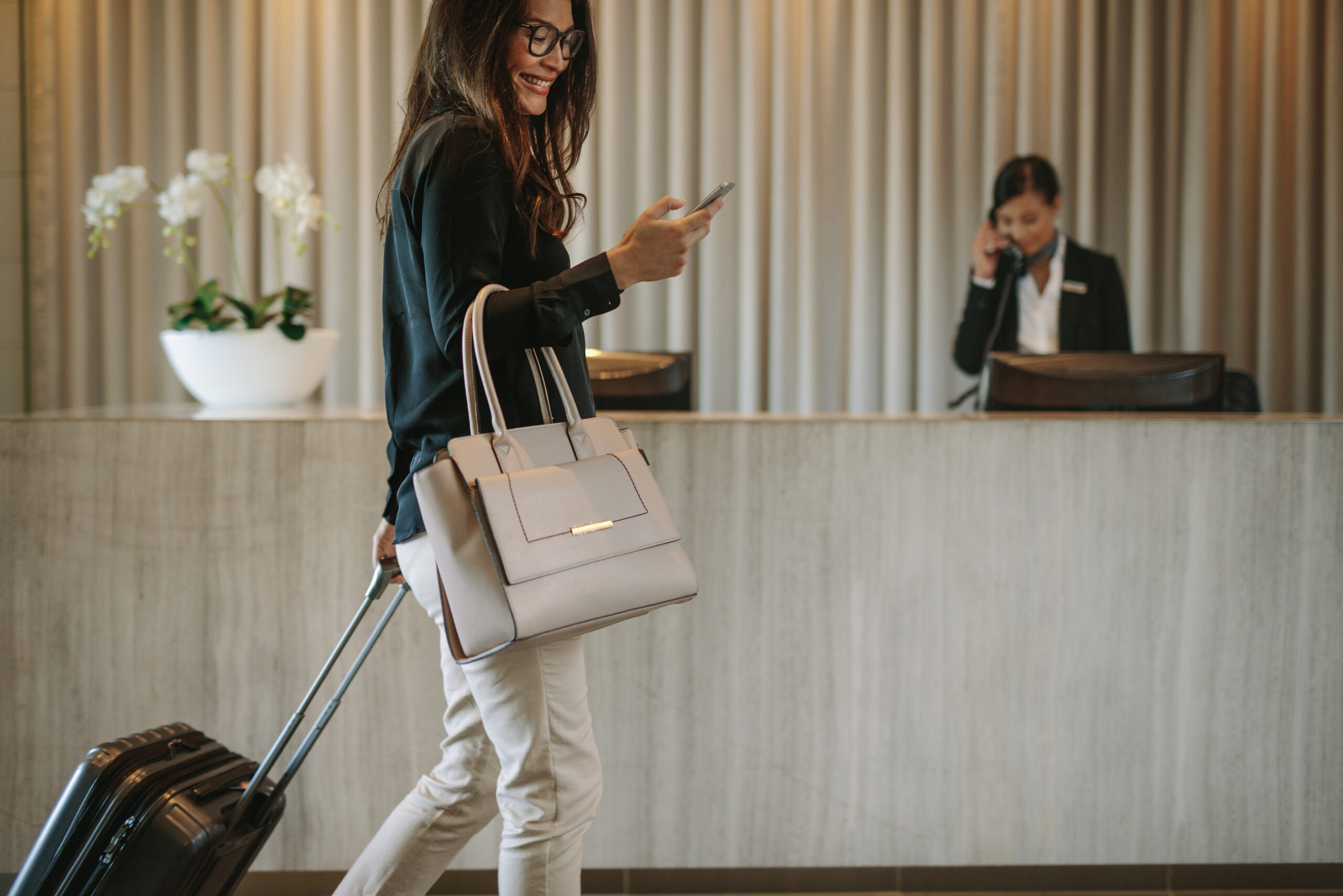 Travller arriving at hotel accommodation with suitcase